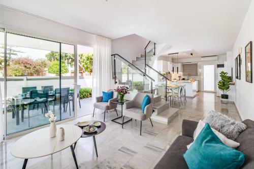 a living room with a couch and a table at Luxurious ONE Maisonette by Ezoria Villas in Paphos