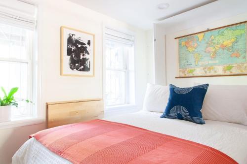 a bedroom with a bed with a map on the wall at Capitol Hill Studio - Sub Walkscore W D in Washington, D.C.
