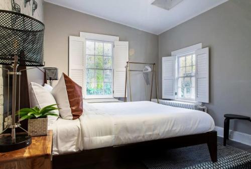 a bedroom with a white bed and two windows at IDEAL GEORGETOWN STAY \ PARKING! \ W/D in Washington, D.C.