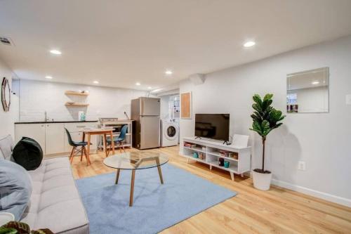 a living room with a couch and a table at SUNNY, SERENE & CENTRALLY-Located STUDIO *PRIVACY *COMFORT *5-STARS in Washington, D.C.
