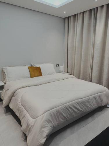 a large bed in a room with a window at Quite and Cozy in Seeb