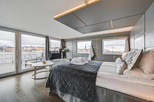 a bedroom with a large bed and large windows at Rygerfjord Hotel & Hostel in Stockholm