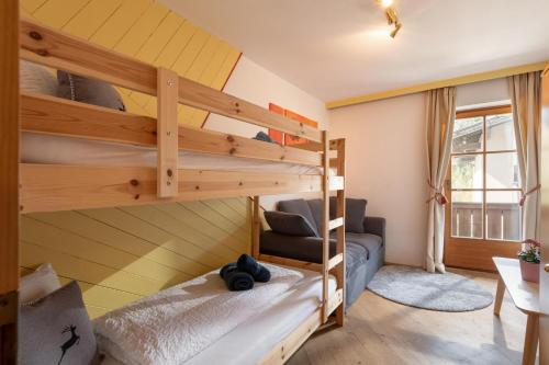 a room with two bunk beds and a desk at Apartment Gisela in Hopfgarten im Brixental