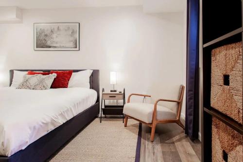 a bedroom with a bed and a chair and a table at Fantastic Falls Church HomeBase for DC area travel in Arlington