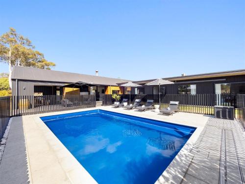 a swimming pool in front of a house at Casa Burnside in Margaret River Town