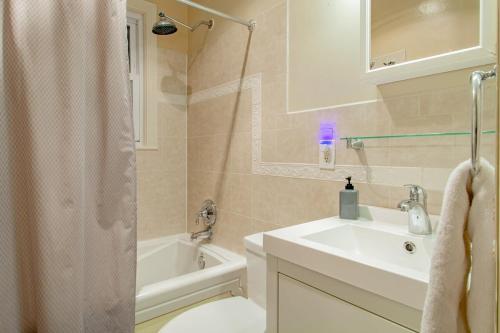 a bathroom with a sink and a toilet and a tub at Pentagon City Homestay Parking available in Arlington