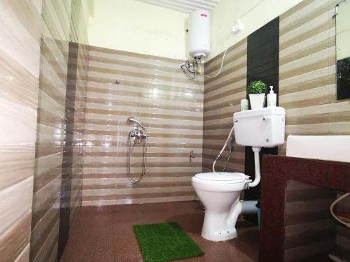 a bathroom with a toilet and a shower at Paul's stay in Darjeeling