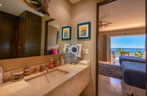 a bathroom with a sink and a large mirror at Views to El Arco, Famous Cabo San Lucas bay rock formation in El Pueblito