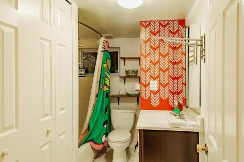 a small bathroom with a toilet and a sink at Rest Easy in this Bloomingdale English Basement in Washington, D.C.