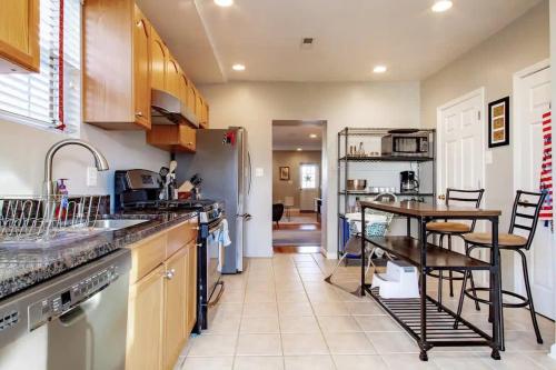a kitchen with a refrigerator and a table in it at Family-friendly Home for travelers Near subway in Washington, D.C.