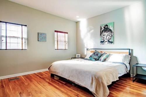a bedroom with a large bed and a wooden floor at Family-friendly Home for travelers Near subway in Washington, D.C.