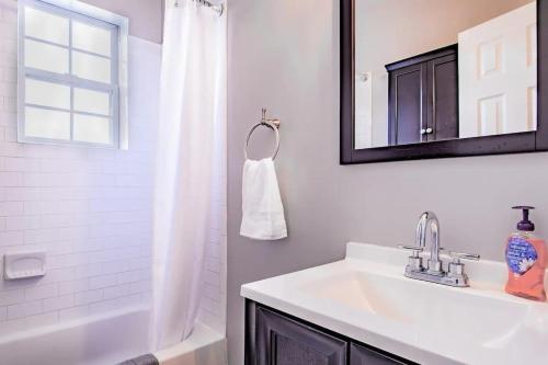 a white bathroom with a sink and a mirror at Family-friendly Home for travelers Near subway in Washington, D.C.