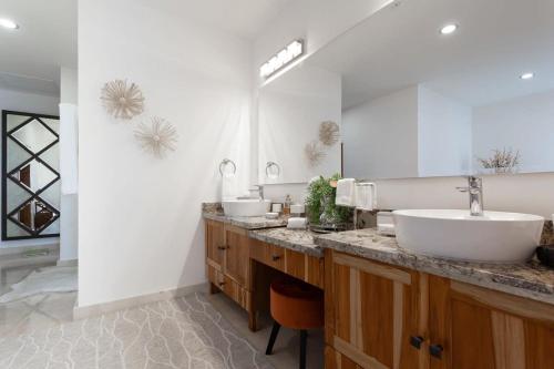 a bathroom with two sinks and a large mirror at Gorgeous estate in Puerto Los Cabos golf and beach community in San José del Cabo