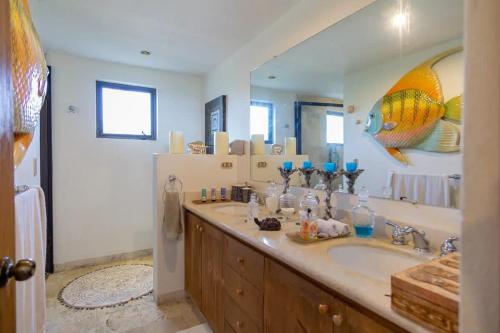 a bathroom with a sink and a large mirror at Las Terrazas Cerro Colorado in El Bedito