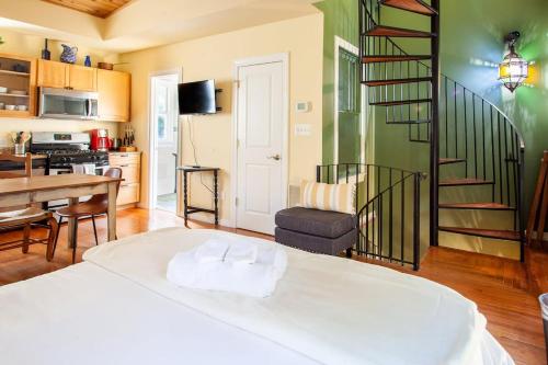 a room with a bed and a kitchen and a staircase at H St Sanctuary Capitol Hill Carriage House in Washington, D.C.
