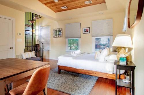 a bedroom with a large white bed and a desk at Historic Capital Hill Home and Carriage House in Washington, D.C.