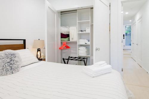 a white bedroom with a large white bed at Bright & Cozy 1-BR Alcove in Bloomingdale in Washington, D.C.