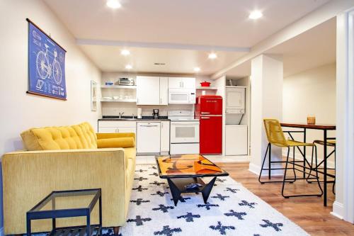 a living room with a couch and a table and a kitchen at Stay Cozy in CoHi DC in Washington, D.C.