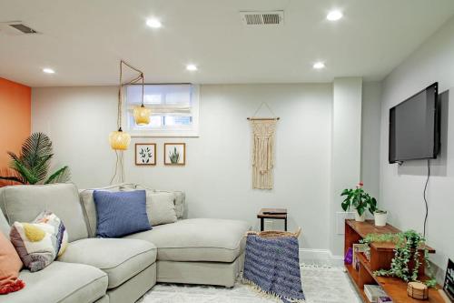 a living room with a couch and a flat screen tv at Private 1-BR DC Residential-Style Stay Parking in Washington, D.C.
