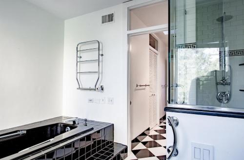 a bathroom with a sink and a glass shower at LUXE Kalorama 5-BR Townhome Close to Dupont Circle in Washington, D.C.