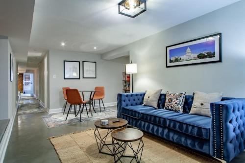 a living room with a blue couch and a table at 2-BR Petworth Pad Walk to METRO Subway in Washington, D.C.