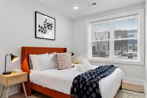 a bedroom with a bed and a window at Excellent 2-BR Condo in Hip Area of DC in Washington, D.C.