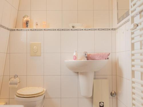 bagno bianco con lavandino e servizi igienici di Ferienwohnung Severin a Bottrop