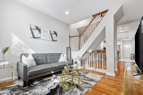 a living room with a couch and a table at Charm City Homestay in Washington Village in Baltimore