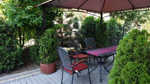 a table and chairs under an umbrella on a patio at Hotel Mieszko in Rzeszów