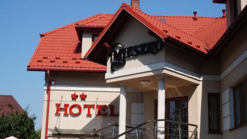 a hotel building with a red roof at Hotel Mieszko in Rzeszów