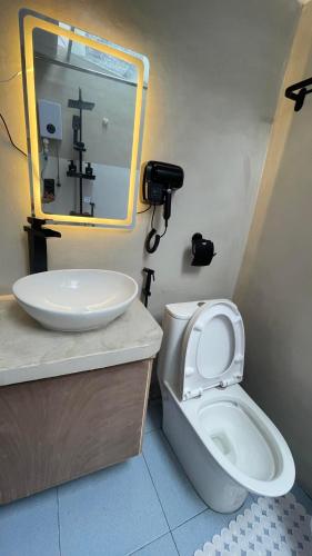 a bathroom with a toilet and a sink at Hayya Hayya Villas in Ocoy
