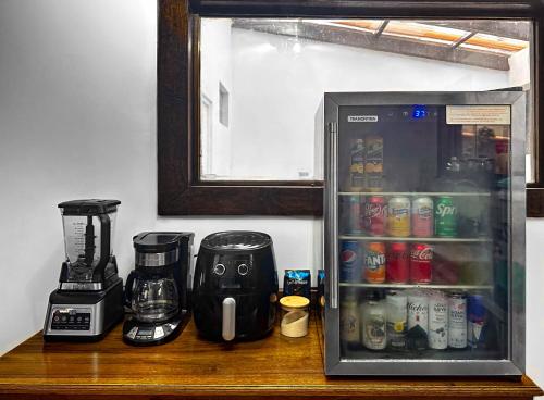 a counter top with a coffee maker and a blender at Alta Terra Hospedajes in Quetzaltenango