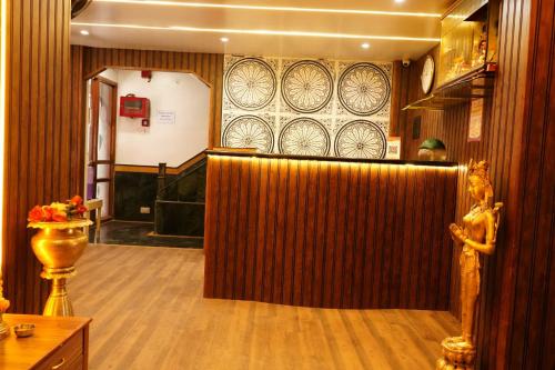 a lobby with a wooden partition in a room at Hotel Padma Krishna in Pune