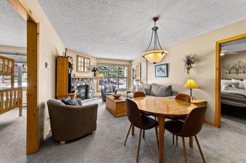 a dining room and living room with a table and chairs at Crystal Forest #51 condo in Sun Peaks