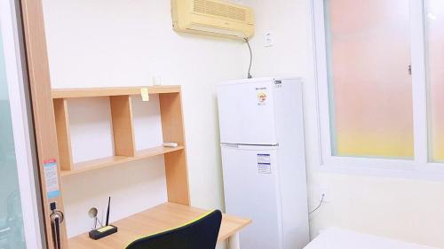 a kitchen with a refrigerator and a table with a chair at J-GGV103 close to Jeonbuk University in Jeonju