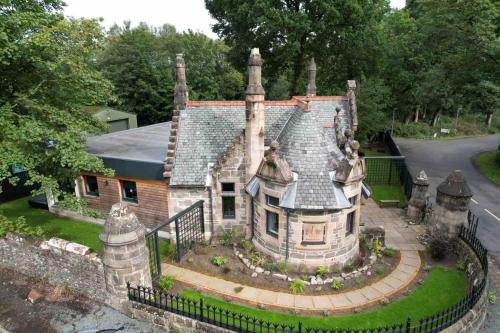 an old house with a roof on a street at Stylish Loch Lomond lodge in stunning surroundings in Balloch
