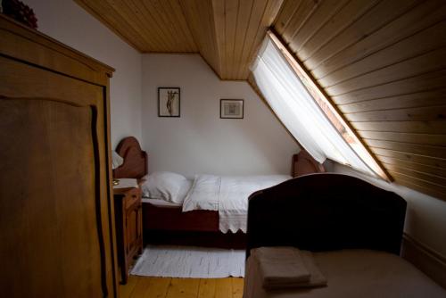 a small bedroom with a bed and a window at Farm Soržev mlin in Nova Cerkev