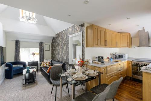 a kitchen and living room with a table and chairs at Flat in Guildford in Stoughton