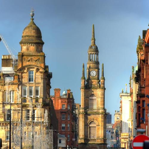 an old building with a clock tower in a city at Glasgow Green Getaway with Free Parking in Glasgow