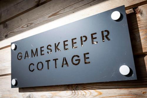 a sign that reads gameskeeper coffee hanging on a wall at New Build Lodge With Stunning Views of Loch Awe in Hayfield