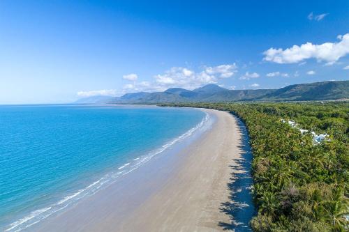an aerial view of a beach with trees and the ocean at The Posh Penthouse With Stunning Rooftop Oasis, Free Parking And WIFI in Port Douglas