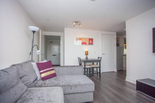 a living room with a couch and a table at Beautiful Flat with Panoramic Views over the City in Glasgow