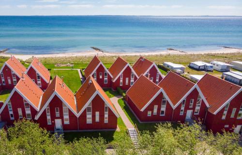 a row of red houses next to the beach at Ocean 1 in Rettin