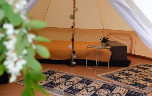 a room with two rugs and a bed in a tent at Glamping Cisnadioara in Cisnădioara