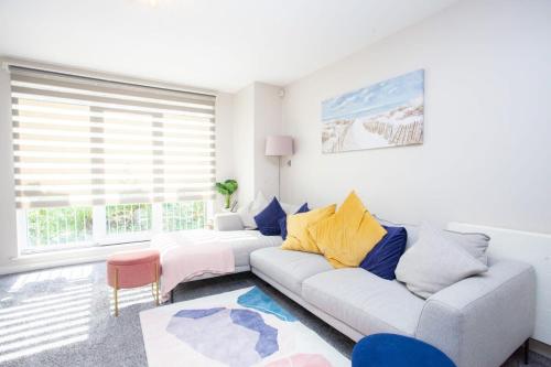 a living room with a couch and a window at Stunning 3 Bed Apartment in Bearsden