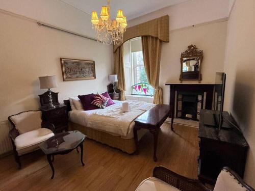 a living room with a bed and a fireplace at Stunning West End 3 Bed in Glasgow