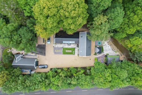 an aerial view of a house in the middle of a forest at The Ultimate Luss Retreat in Luss
