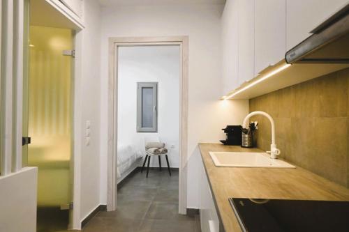 a kitchen with a sink and a counter top at Bluewave Lux house in Ornos