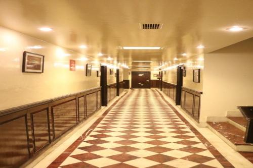 a hallway with a checkered floor in a building at OYO Vatika in Gurgaon