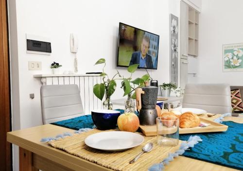 a dining room table with a plate of food on it at HoliHome - Nobil Villani - Bilocale piano terra in Tortoreto Lido